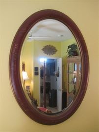 Painted and beveled oval mirror.
