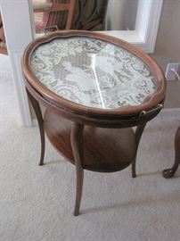 Oval table with a removable lace lined tray.