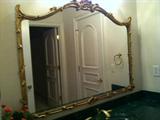 pair of matching mirrors with gold frames