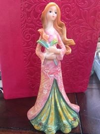 Miniature hard plastic ADORABLE doll . $40.00 OR BEST OFFER she looks like a princess holding a bouquet of flowers , her hair is wavy and blond . Her face is beautiful and soft . Her gown is pink and green ! VERY PRETTY DOLL! Size : 6" WE HAVE MORE PORCELAIN FIGURINES STILL AVAILABLE.