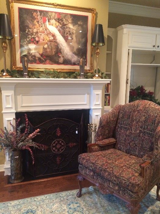 Framed art; matching lamps; brass container with eucalyptus;  fire screen; good-looking wing back chair;