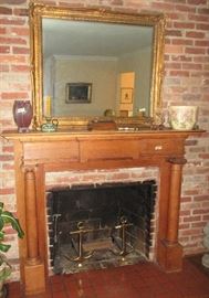 Chestnut mantel, anchor-shaped andirons and American pottery