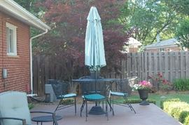 Wrought iron, round patio furniture set w/four chairs.  The set is available on its' own and the umbrella may be purchased separately.  There are also 2 swivel chairs available that coordinate well with this set.