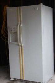  GE Side by side refrigerator - white.  There is a water/ice dispenser in the door.