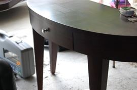 A sofa table on a sherry finish.  Contemporary in styling.  It  has a storage drawer with satin hardware.  