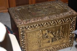 A  very well made brass trunk with ornate carving on the top and front.