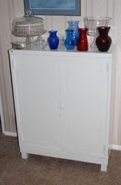 This cabinet is a metal cabinet,  very heavy and very vintage.  It opens to reveal several shelves.  It has great storage capacity and is very striking.