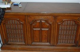 A solid walnut stereo system.  It has AM/FM stereo, a turntable and an 8 track player.  The wood is beautiful and looks great in any room.  the sound quality coming through the built-in speakers is quite remarkable.