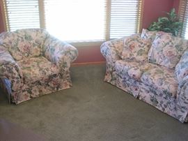 Floral love seat and matching armchair.