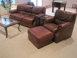 Leather sofa with matching armchair and ottoman.
