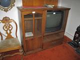 Beautiful narrow entertainment center with tambor doors. Nice color oak, on wheels too.