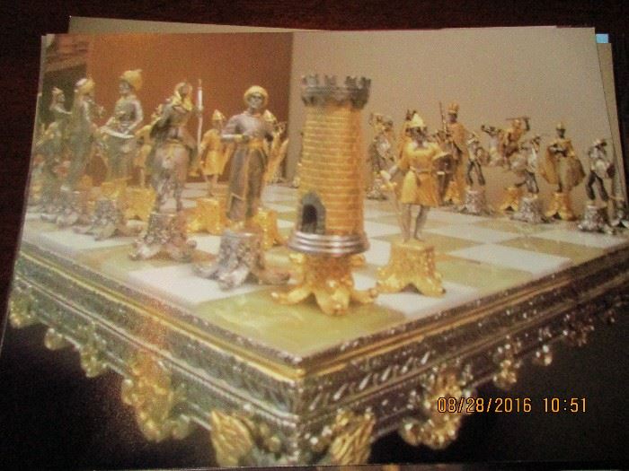 On site only during sale.La Bottega del Vasari Chess Set painted with gold/silver and bronze. Italian marble top 20/200. with velvet covered seats. Purchased in New York for $10,000. Firm price of $6500.00 by appointment only.