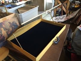 Metal display case with door propped open with brackets. New with box. 34" x 22"