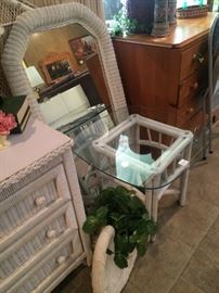 White wicker mirror and small glass top table