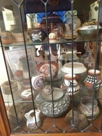 Native American pottery collection and curio cabinet