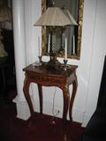 table, silver candleholders and lamp