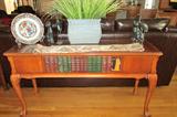 This nice queen Anne sofa table with book embelishments is perfect for a den, library, front foyer table etc.  Just one of many wonderful unique pieces at this estate sale.  The kitties and storks sculptures are so cute on this table.