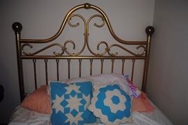 Brass bed, quilt pillows
