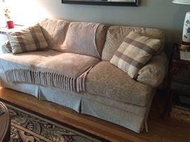 Cream colored, clean couch. Very comfortable! Thomasville