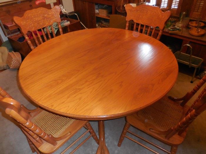 GORGEOUS!!! OAK Round Table with Leaves. Pads. Hand Carved Claw/Ball Foot Pedestal. Has 6 Hand Carved Oak Side Chairs/Cane Seats. Looks better up close!! :)
