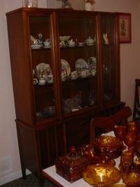 Mid-Century china cabinet to match the 1950's mahogany table & chairs...obviously filled with a large tea cup & saucer collection, plus fine pressed and cut glassware.