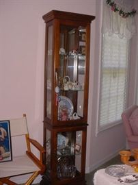 Tall curio cabinet, filled with many items