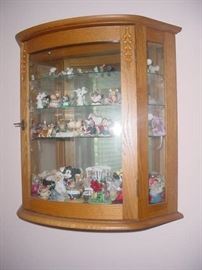Oak wall cabinet filled with a unique "mice" collection.