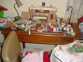 Singer sewing machine, with cabinet, and SO MUCH sewing supplies, and craft related items all over