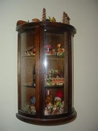Wall cabinet filled with old wooden German ornaments, and more