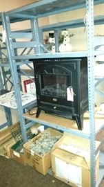 Many metal and Rubbermaid style shelving units.  Charmglow electric fireplace.