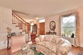 Floral loveseat, glass top metal cocktail table, pair of Rose slipper chairs