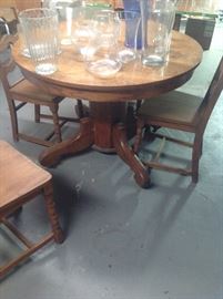 Antique round oak pedestal base table with two leaves