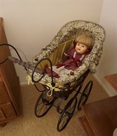 Cute doll in a doll stroller