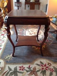 Side table with lion face carvings