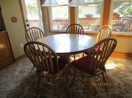 Solid oak table, leaf and 6 chairs(6th chair not pictured here)