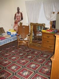 Area rug, wood rocker and Magic Johnson's cardboard stand pic