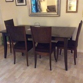 Beautiful Dark walnut Contemporary dinette Set, dark walnut in color, with leaf seats 8, 6 matching chairs with dark-suede cushions, easy to wash off.  $375.00.