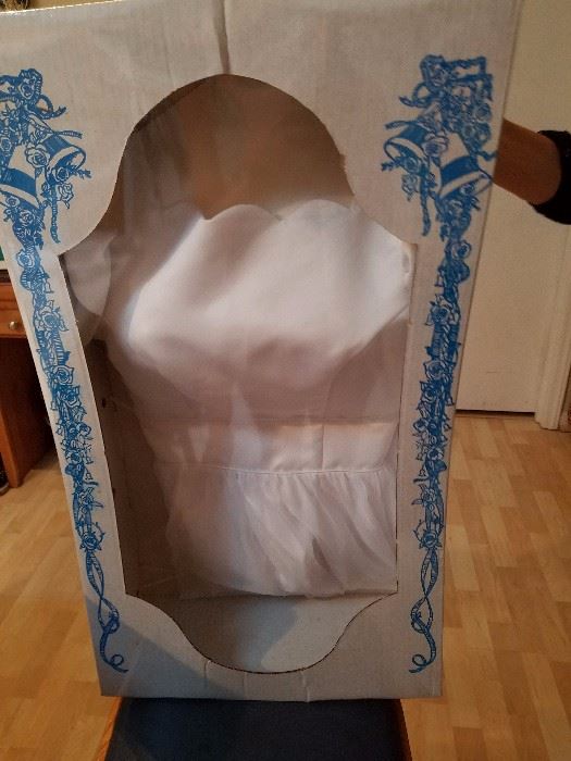Tea Length Wedding Dress...Sealed for protection. Professional designed and made in 1993.  Scalloped neck line, open back, white in color, short sleeves, fitted waste, size 2-4, asking $550.00