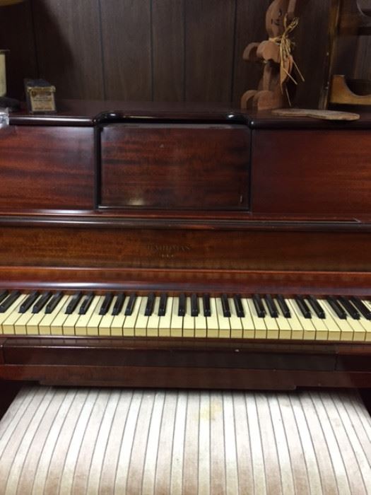 Player piano just $400! Many rolls to this great piano and nice piano bench.