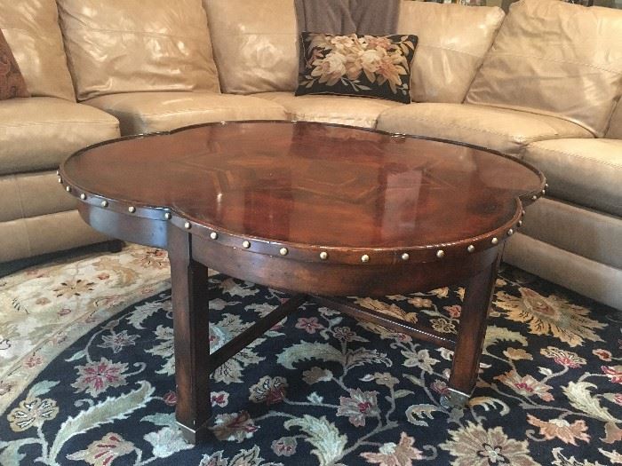 Portsmouth Finish Clover Top Cocktail Table with Brass Tacks and Wheels