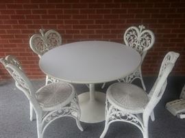 Four vintage wicker chairs and mid century table
