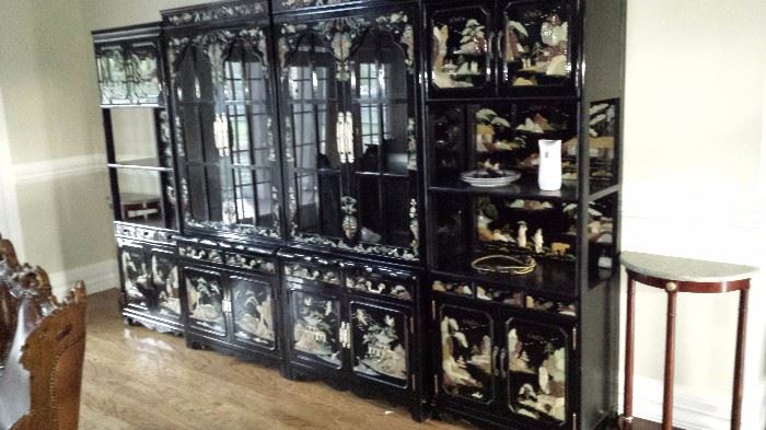Grouping of 4 Korean cabinets with mother of pearl, jade and granite carvings-center glass front cabinets are lighted. 