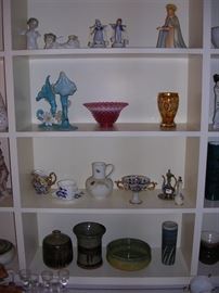 The figurines are LLadro, Goebels and German. Notice the Pottery on the lowest shelf.