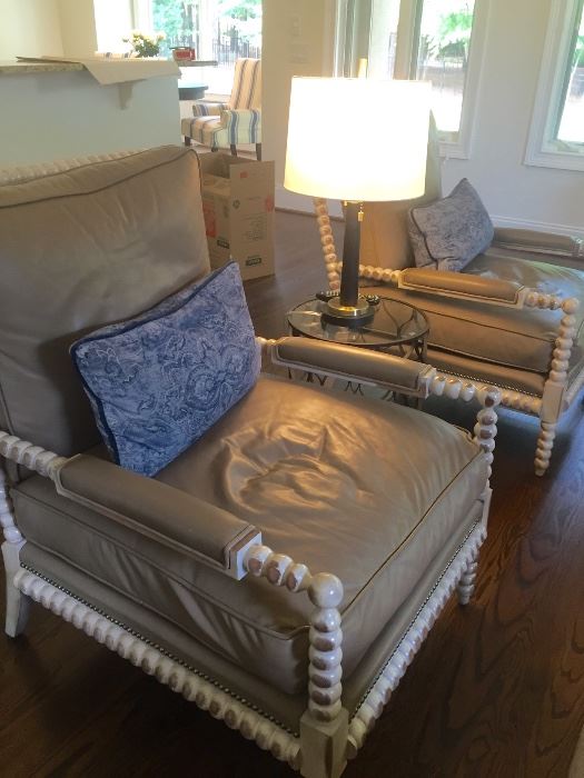 Pair of gray leather arm chairs with wood trim