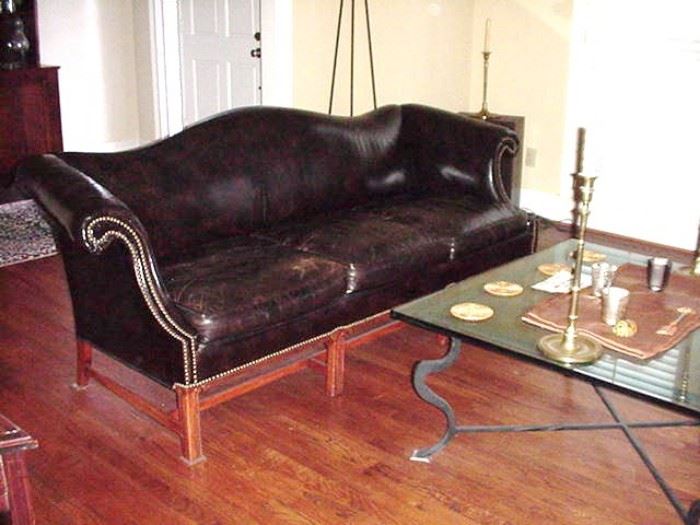 Black leather Chippendale style sofa with brass upholstery tacks