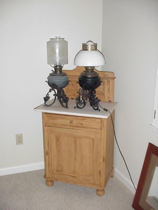 Single door wash stand with marble top, pine--two old kerosene lamps, Bradley and Hubbard on right is electrified.  Other lamp has fabulous etched shade.  