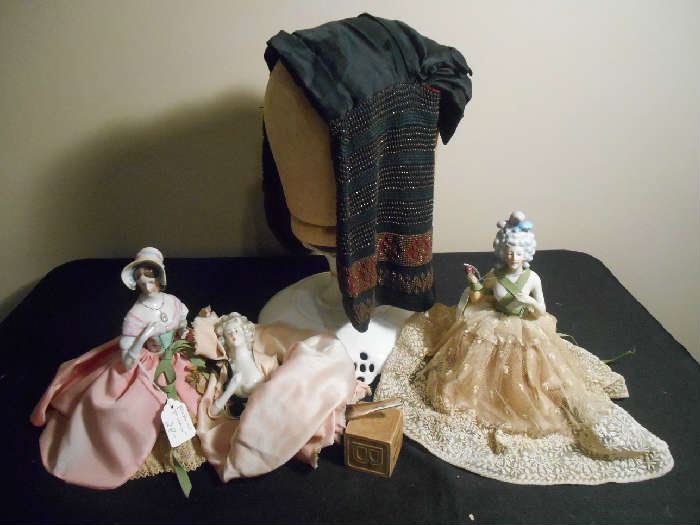 Family Room-SMALLS area:  Closer photos of some of the items in the previous photo:  The CIVIL WAR era head covering is on the wooden head.  It is beaded and drapes over the head but has a place in the back for the hair (think about a "GONE WITH THE WIND" fashion of the 1860's); three porcelain body dolls:  one is a pin cushion, one has a metal dress frame, and the one in the middle is a perfume stopper--you can see the long glass stopper resting on the wooden block if you look closely.
