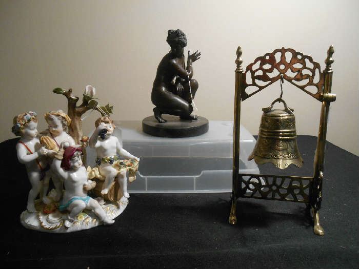 Family Room-SMALLS area: These items are actually displayed on the top of the glass case--we just moved them to photograph in better light:  a porcelain DRESDEN piece (as is); a nude bronze; and a brass Chinese Dinner Bell (1920-1925) of Ch'ing Dynasty style which uses a small brass mallet instead of a clapper.
