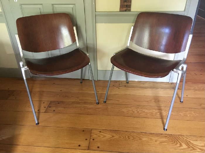 A pair of mid century Giancarlo Piretti designed chairs by Castelli.  In beautiful original condition, date to the 1960's.  Dark Wood