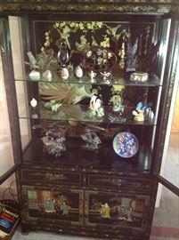 Black lacquer cabinet with jade and amethyst figurines